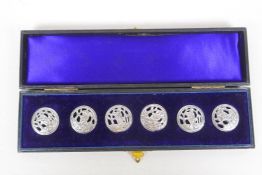 A cased set of six antique hallmarked silver buttons depicting a figure working the fields, Chester,