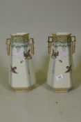 A pair of porcelain vases with gilt highlights and raised decoration depicting flying geese, 31cm