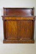 A C19th mahogany chiffonier, the top shelf with three quarter pierced brass gallery, over a base