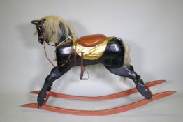 A vintage painted rocking horse, 100cm high, 160cm long