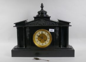 A C19th slate mantel clock of classical form, with carved decoration to the pediment and brass