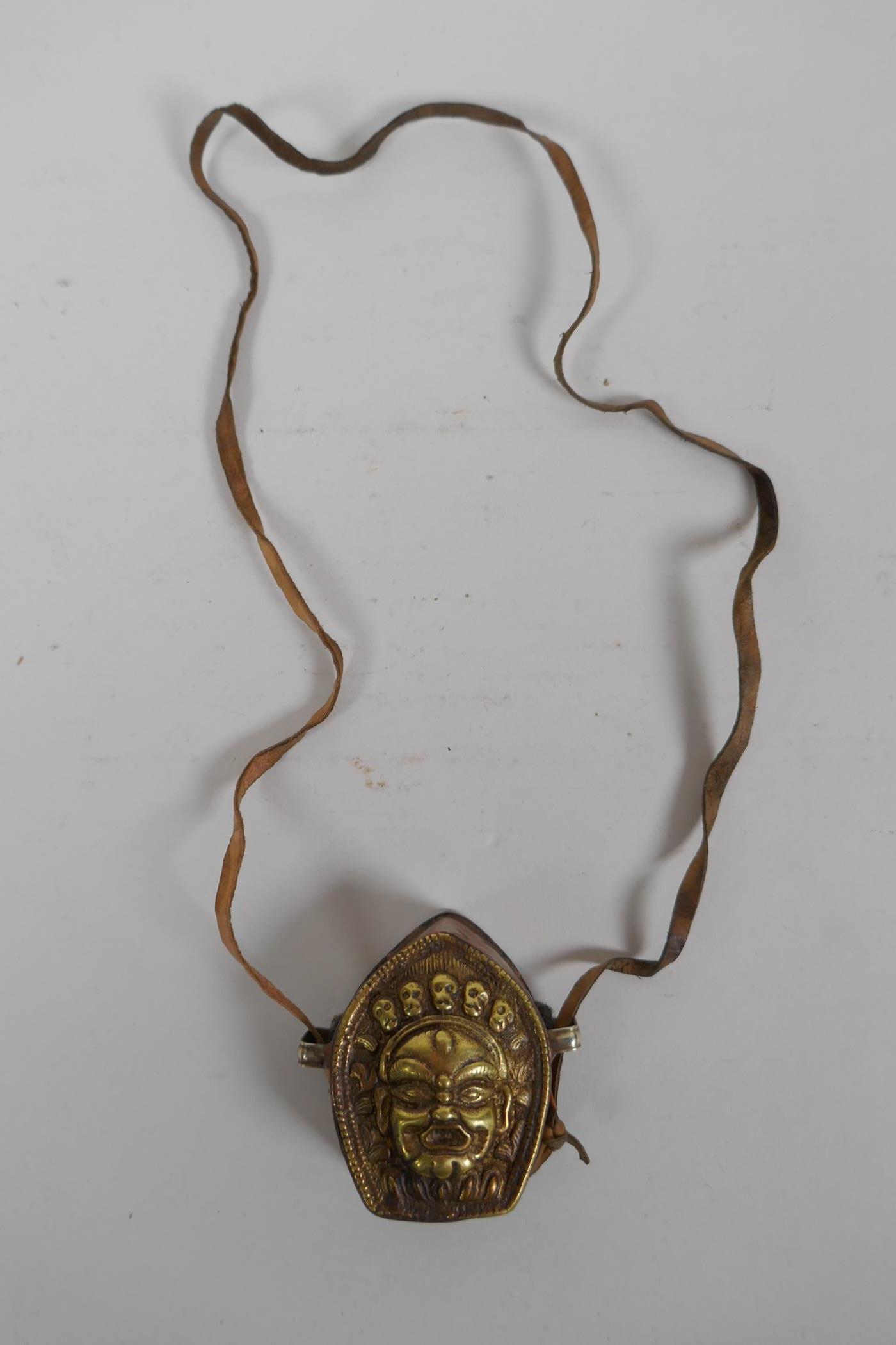 A Tibetan copper and brass Gau box, with repousse wrathful deity mask decoration, 4 x 6cm - Image 2 of 3