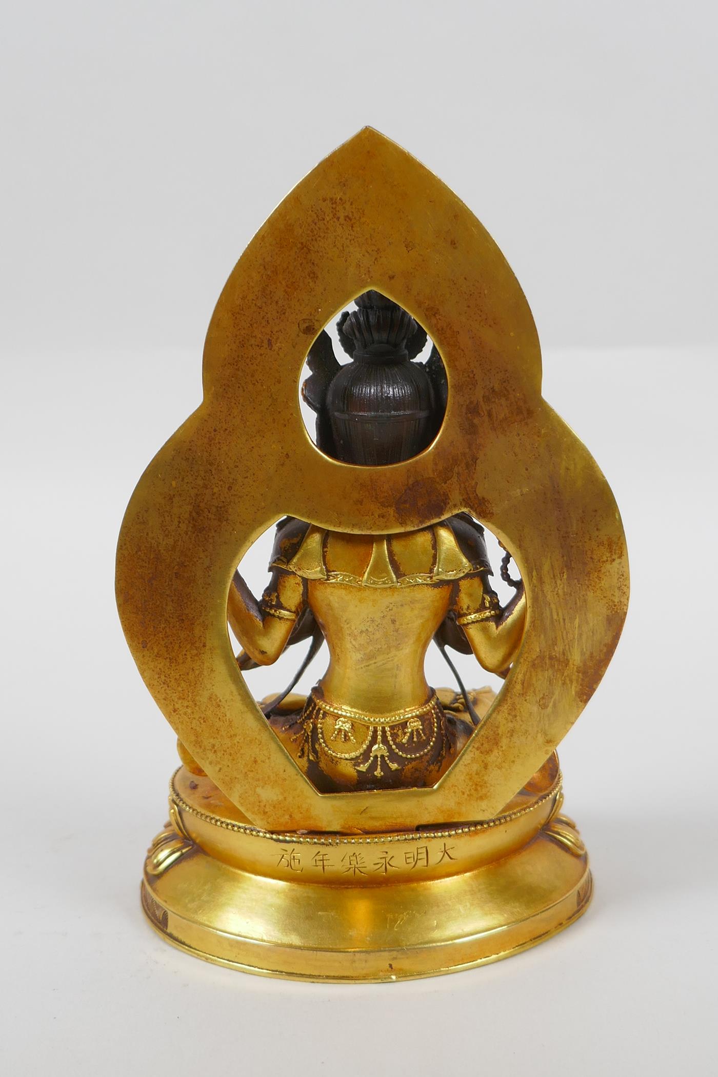 A Sino Tibetan gilt bronze figure of Buddha, double vajra mark to base, 17cm high - Image 3 of 5