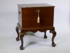 A George III mahogany wine cooler with lift up top and zinc lined interior, raised on a base with