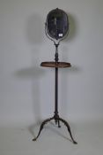 A C19th painted metal gentleman's shaving stand with tilt and swivel mirror and telescopic stand,