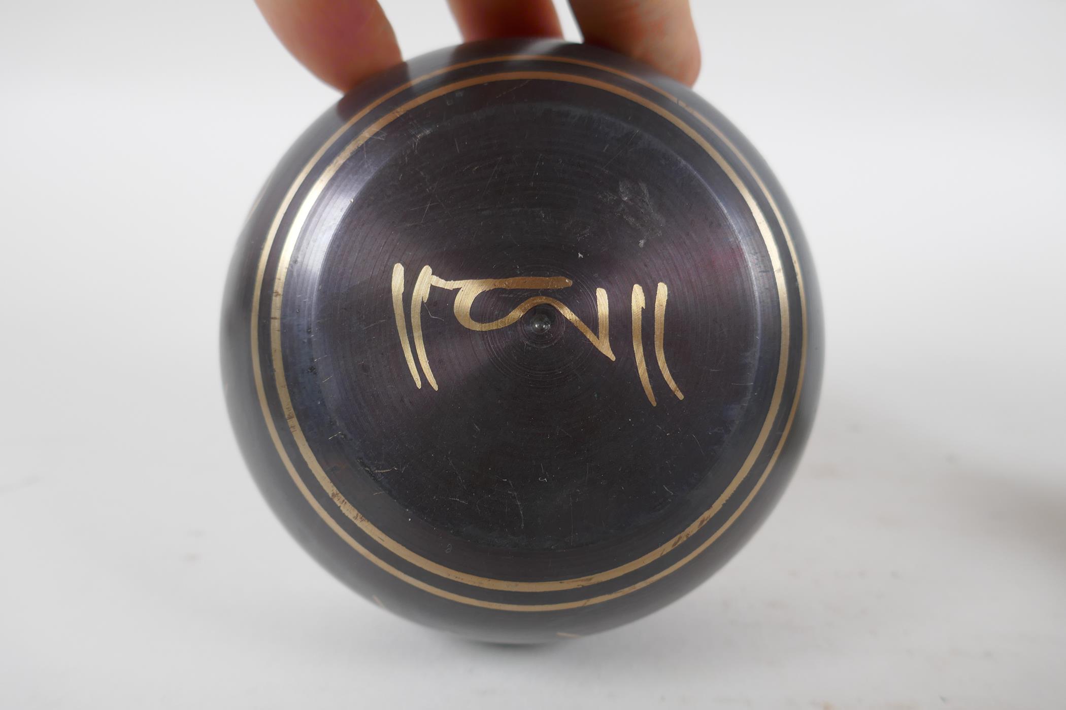A Tibetan bronze singing bowl and beater with script decoration, a brass ceremonial bell with - Image 4 of 5