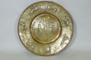 A Nuremburg brass alms dish, the central field with a depiction of Adam and Eve with the Tree of