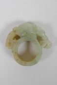 A Chinese Nephrite archers thumb ring with carved mythical creature decoration