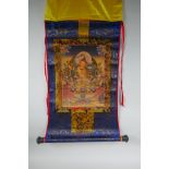 A Tibetan printed thangka in a silk scroll mount with gilt illuminated details, 48 x 62cm