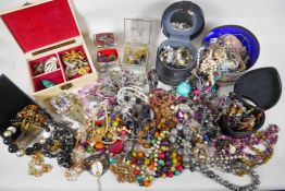 A large quantity of vintage costume jewellery and jewellery boxes, including necklaces, pendants,