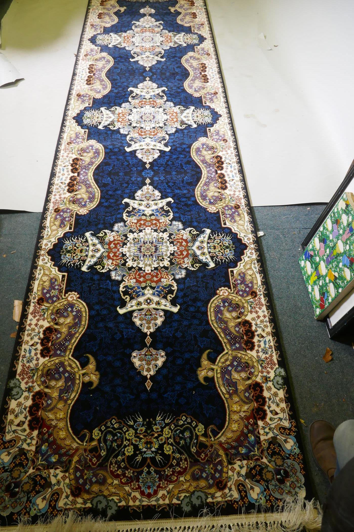 An Iranian fine woven runner with floral medallion design on a deep blue field, 100x  410cm - Image 3 of 8