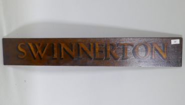 An antique wooden hand painted 'Swinnerton' sign, 92 x 15cm