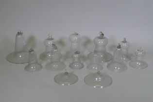 A collection of antique glass bell jars, largest 30cm high