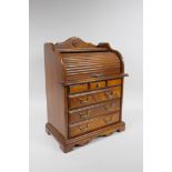 A mahogany jewellery cabinet in the form of a four drawer cylinder desk, 28 x 18cm