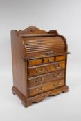 A mahogany jewellery cabinet in the form of a four drawer cylinder desk, 28 x 18cm