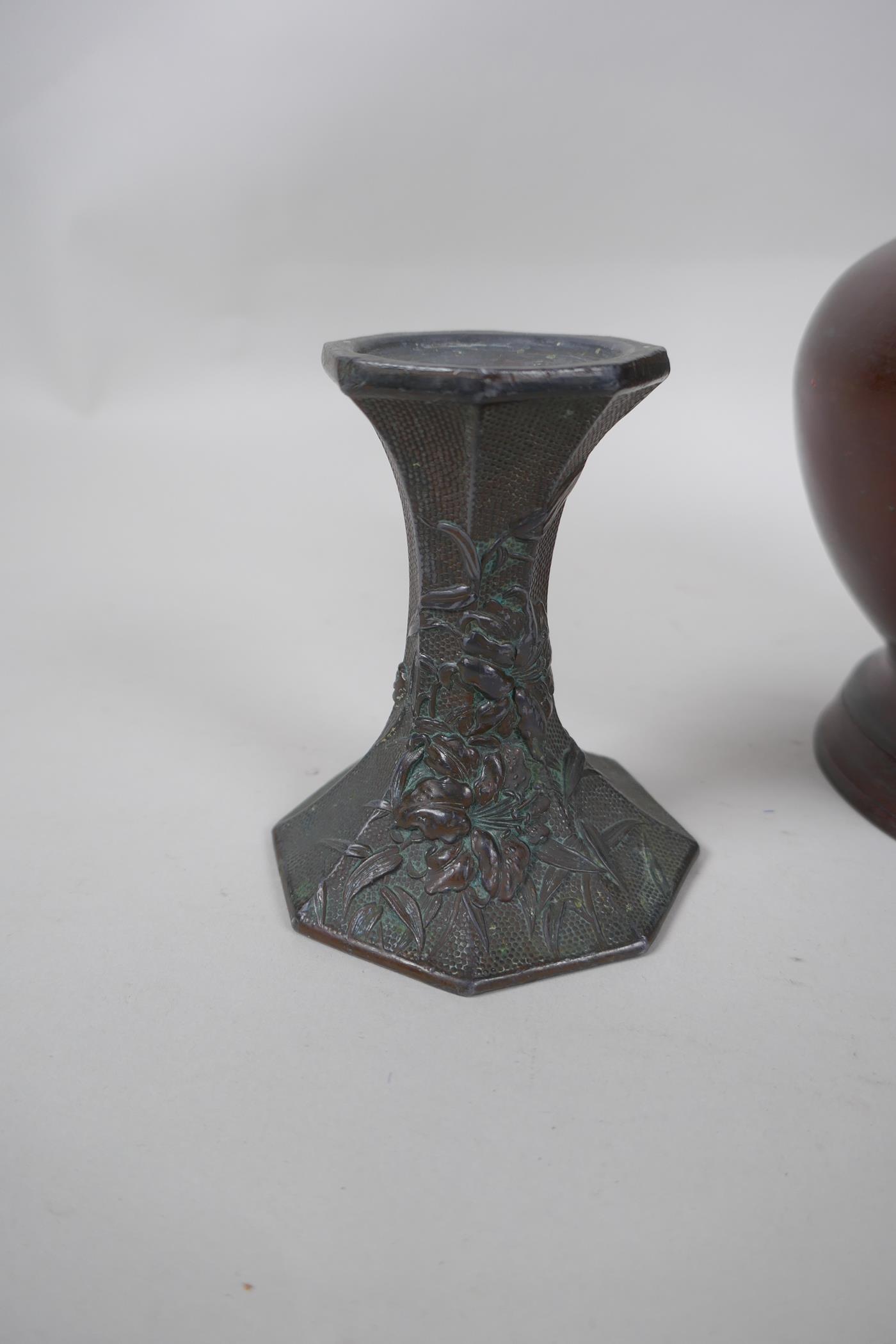 A pair of early C20th Japanese bronze candlesticks of hexagonal waisted form, with raised floral - Image 2 of 6