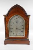 A fine early C19th gothic style rosewood bracket clock, the arched case with pierced sides and