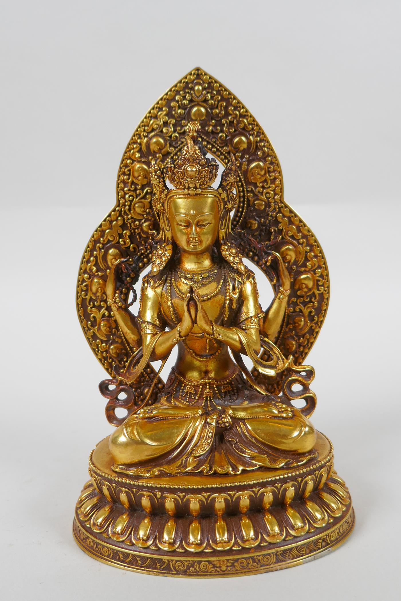 A Sino Tibetan gilt bronze figure of Buddha, double vajra mark to base, 17cm high