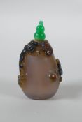 A Chinese agate snuff bottle with carved kylin and ruyi decoration, 6cm high