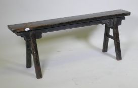 An antique oriental hardwood trestle shaped bench, 131 x 35 x 51cm high