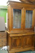 A Grange hardwood buffet a deux corps, the upper section with two glazed doors, the base with