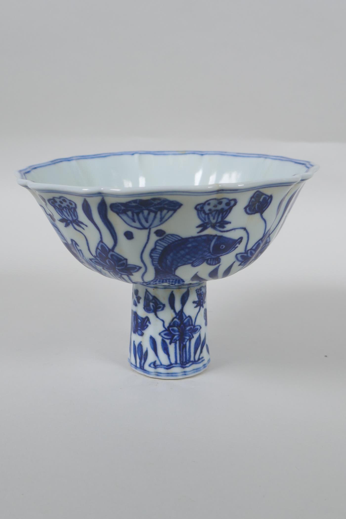 A Chinese blue and white porcelain stem bowl of lobed form decorated with carp in a lotus pond, - Image 4 of 7