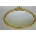 A gilt oval mirror with bevelled glass, AF losses, 82 x 60cm