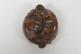 An oriental cast bronze rondel in the form of two water buffalo and a Yin Yang emblem, 6cm diameter