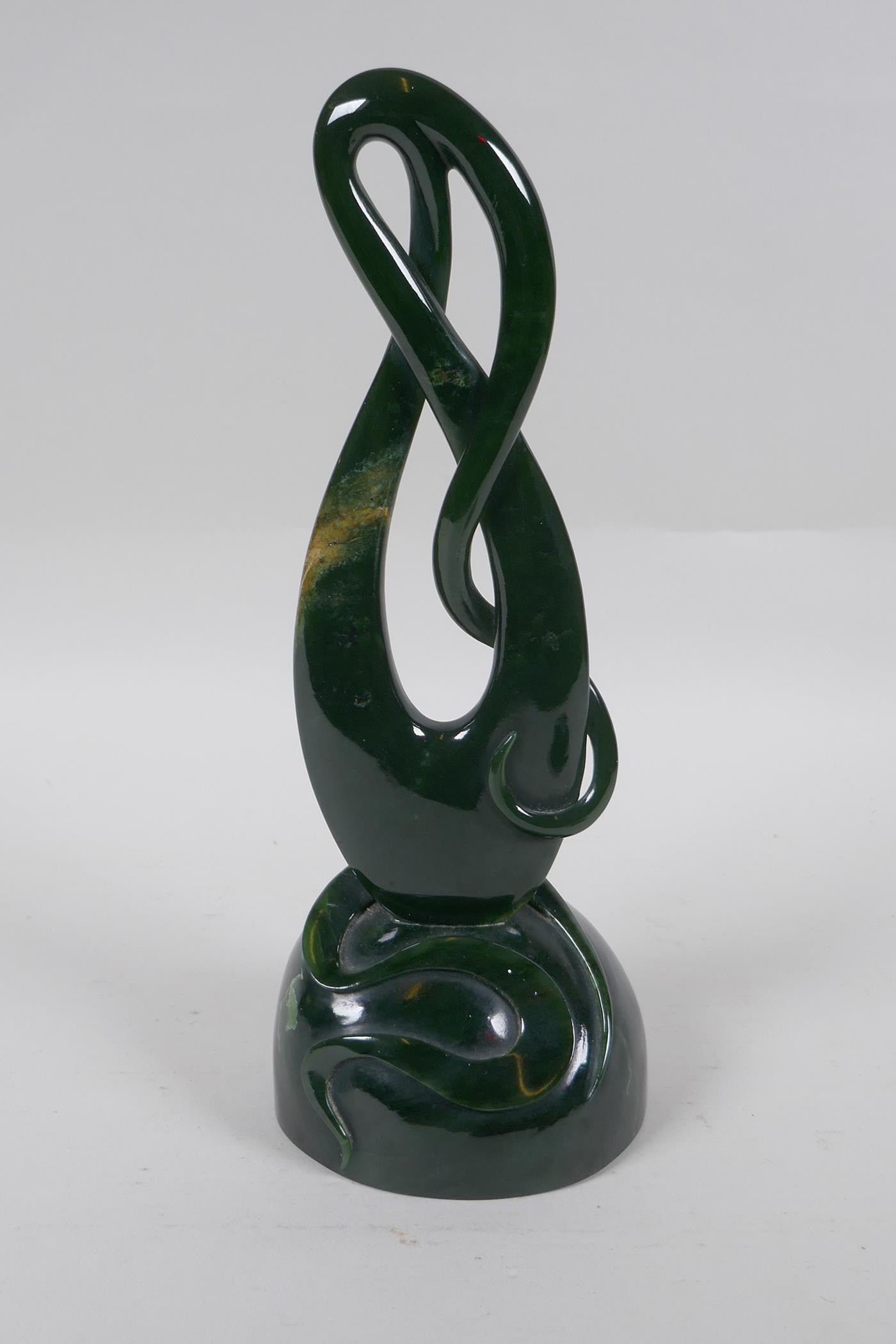 A carved New Zealand spinach jade (Pounamu) abstract sculpture, 27cm high
