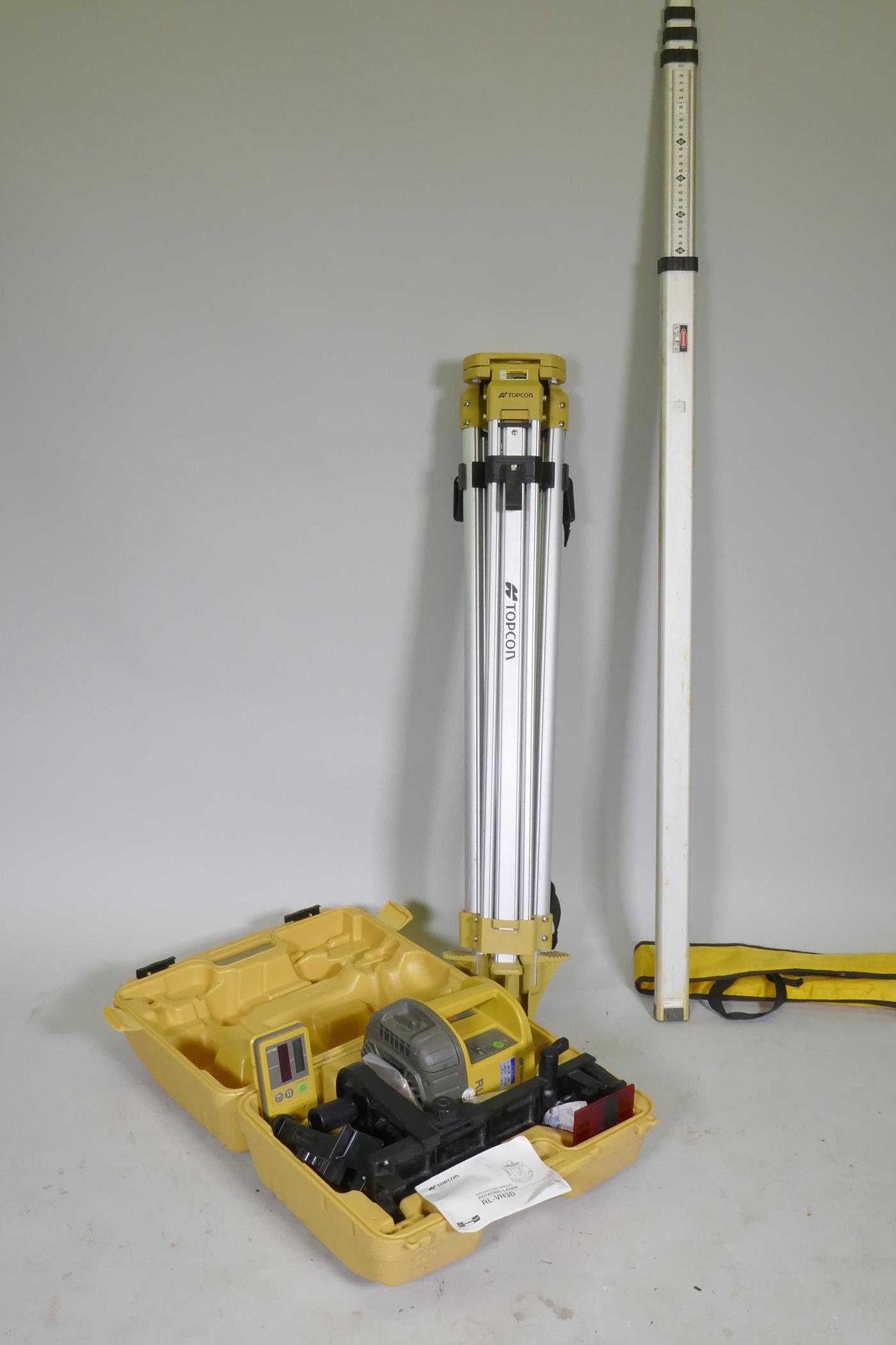 A Topcon RL-VH3D Rotating surveyor's laser, with tripod and staff