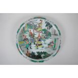 A famille vert porcelain dish with rolled rim, decorated with warriors in a landscape, Chinese