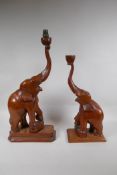 A near pair of carved wood elephants, drilled and part converted for lamps, 57cm high