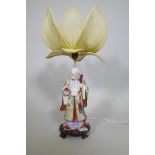 A Chinese porcelain table lamp in the form of Shao Lao holding a peach and staff with dragon's head,