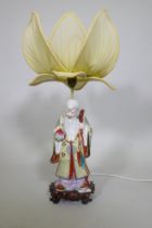 A Chinese porcelain table lamp in the form of Shao Lao holding a peach and staff with dragon's head,