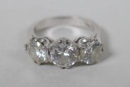 A platinum set three brilliant cut diamond ring, the central stone approx 0.95ct, flanking two