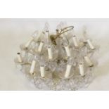 An eighteen branch crystal glass chandelier