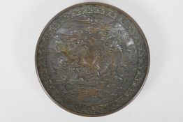 A Chinese bronze dish with raised kylin decoration, Xuande 4 character mark to base, 18cm diameter