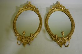 A pair of Victorian giltwood and composition three branch girondelle wall mirrors, 96cm long
