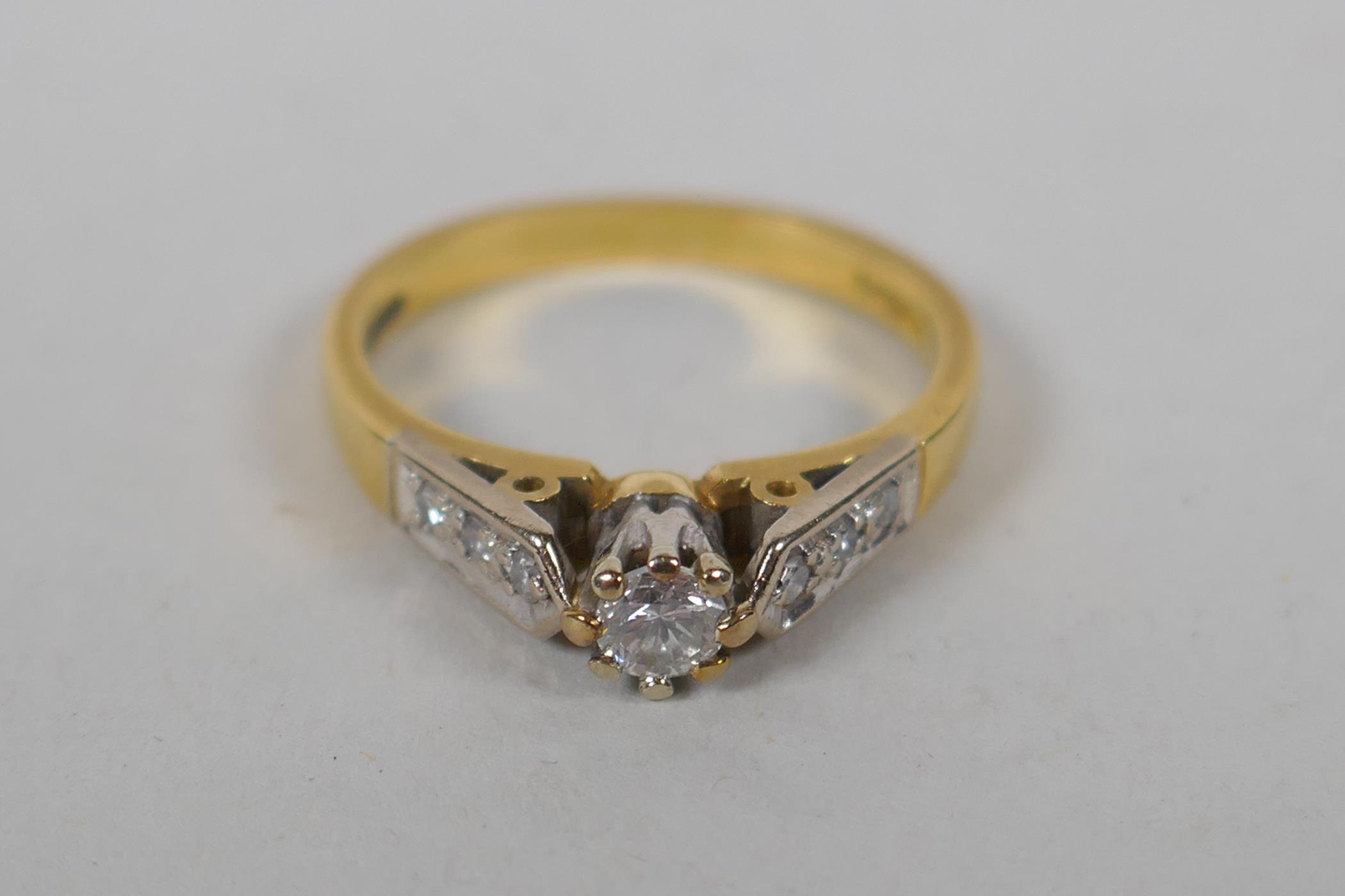 An 18ct yellow gold and diamond ring, with a central set diamond and three diamonds set to each