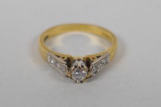 An 18ct yellow gold and diamond ring, with a central set diamond and three diamonds set to each