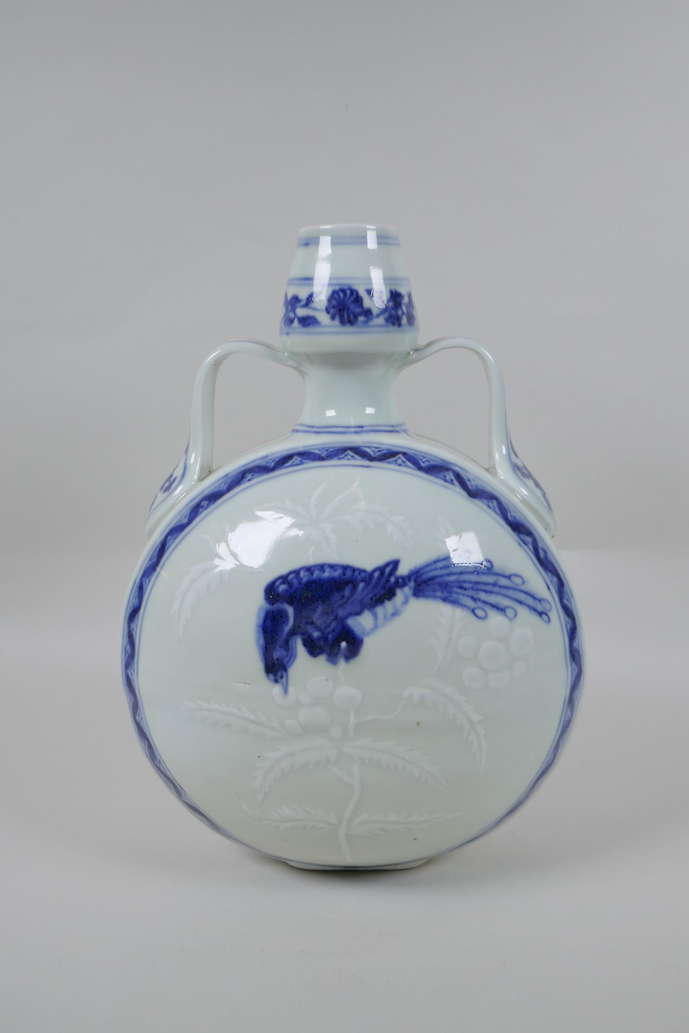 A Chinese blue and white porcelain garlic head shaped moon flask with two handles, decorated with