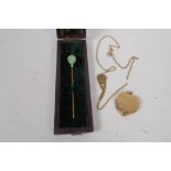 A 9ct gold heart shaped locket and chain, 7.3g, and a 14ct gold hat pin set with jade and a pearl