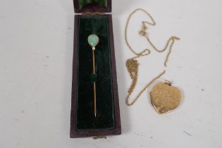 A 9ct gold heart shaped locket and chain, 7.3g, and a 14ct gold hat pin set with jade and a pearl