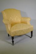 A C19th bow back arm chair with shaped front, raised on turned supports with brass castors