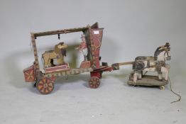 A C19th Folk Art scratch built circus wagon with lions and lion tamer, with moving limbs operated by