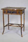 A Victorian Aesthetic oriental style bamboo and lacquer writing table, with leather inset top and