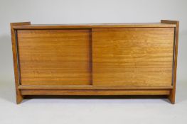 A mid century rosewood side cabinet with two slide doors, 125 x 46 x 65cm