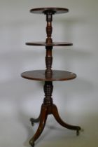 A Georgian mahogany dumb waiter with three revolving tiers, each united by a 'beehive' style ring