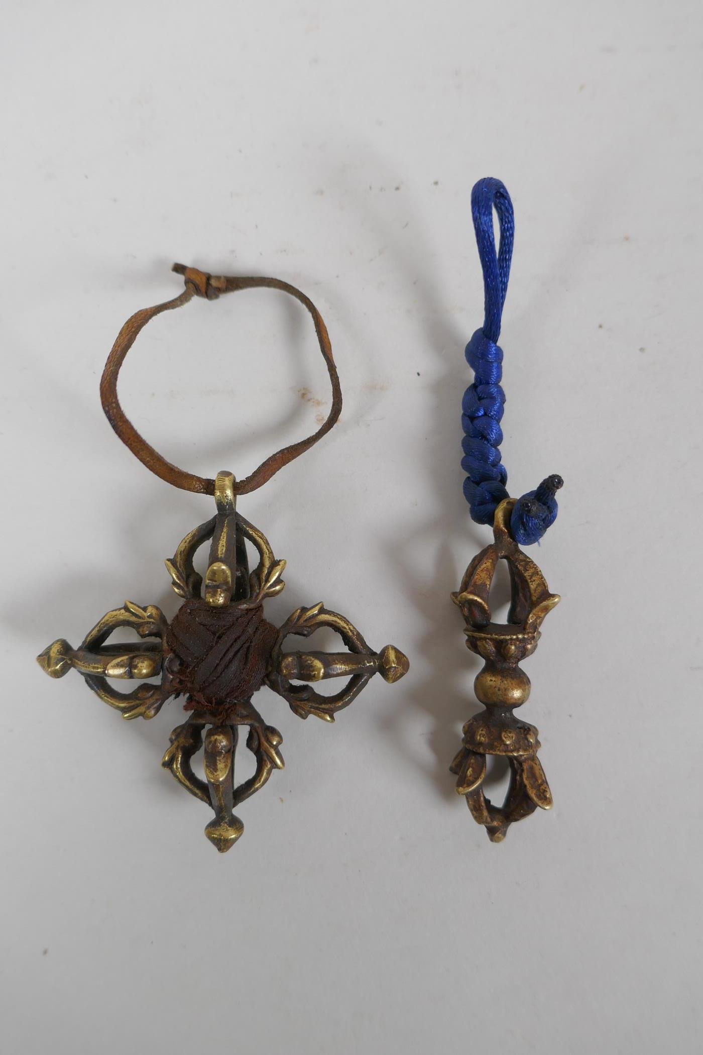 A small Tibetan bronze double vajra pendant and a similar sized vajra pendant, 6 x 6cm