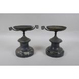 A pair of Grand Tour style bronze urns on marble socles, AF, 18cm high